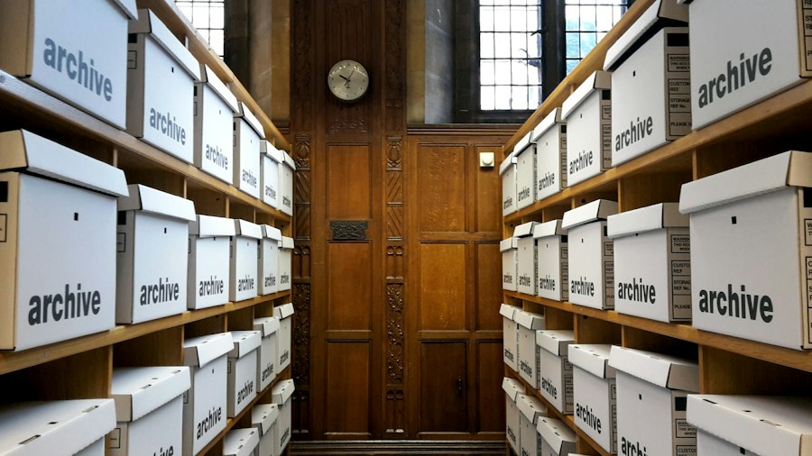 Rows of archive boxes on wooden shelves