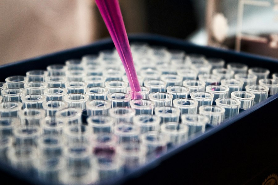 A pipette filling rows of sample tubes in a lab