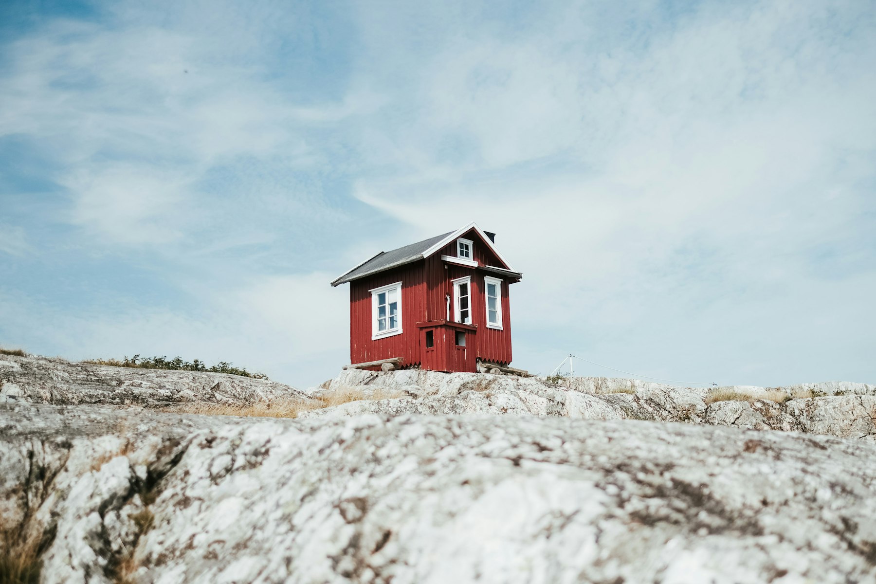 A red wooden house on bare granite bedrock in Vrångö, in the Gothenburg archipelago, Sweden